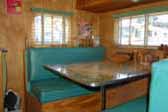 Photo of upholstered bench seats and dining table in vintage 1949 Star Trailer